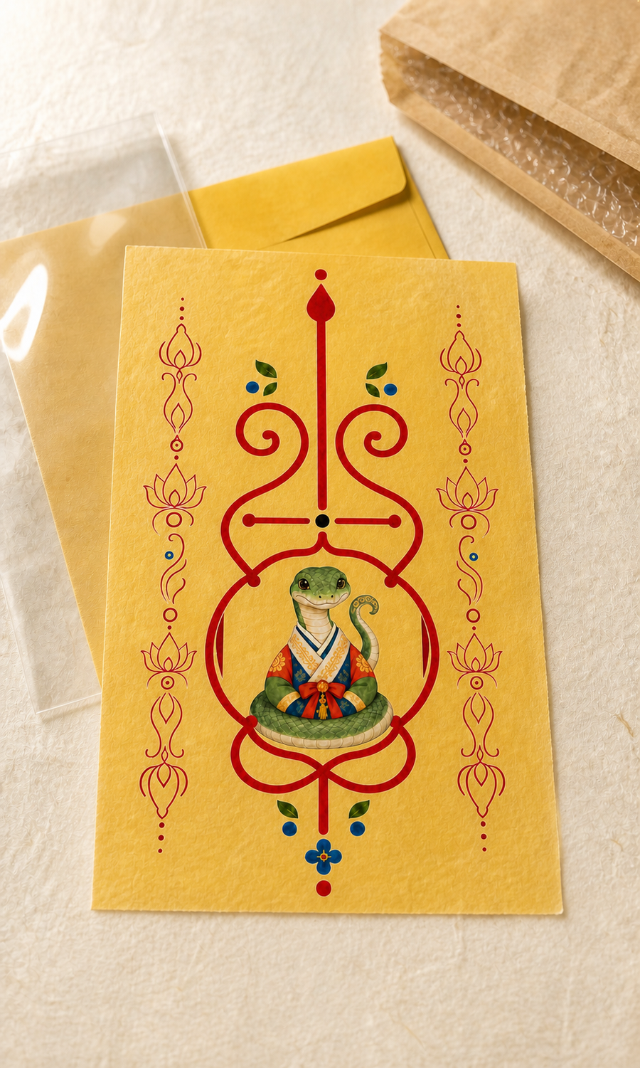 Digital mockup of Snake Guardian Bujeok artwork on a yellow hanji sheet with illustrative packaging; finished print and packaging may differ — Obang House